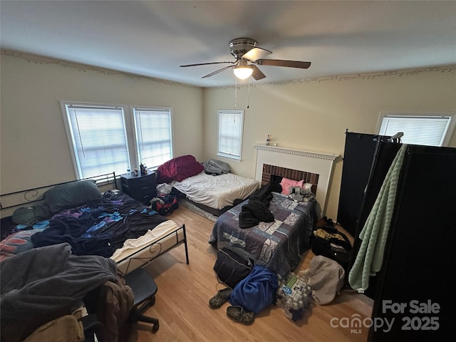 bedroom with a ceiling fan and wood finished floors