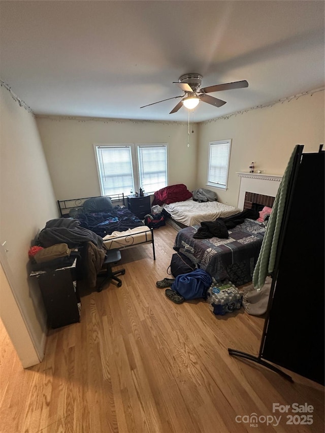 bedroom featuring a ceiling fan and wood finished floors