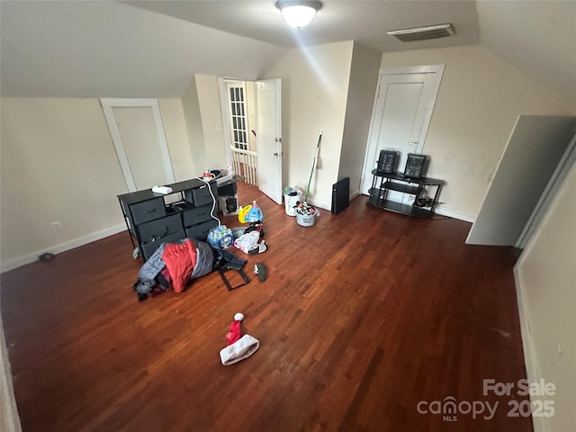 additional living space featuring visible vents, wood finished floors, and lofted ceiling