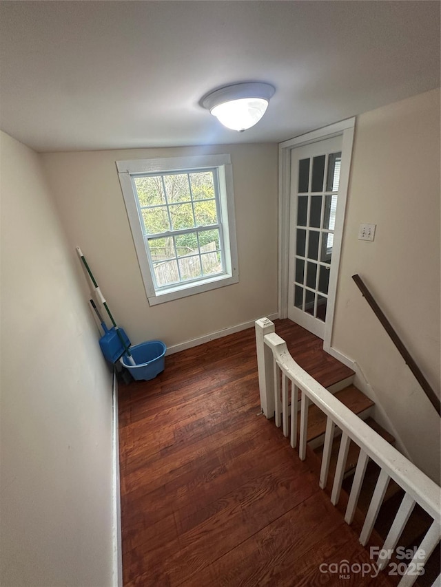 stairs with baseboards and wood finished floors
