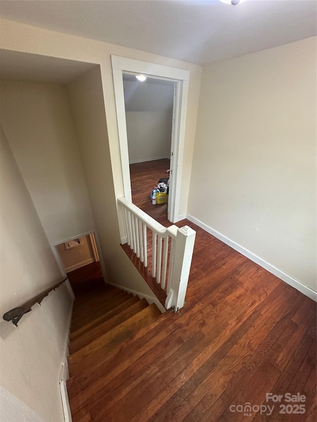 stairs with baseboards and wood finished floors