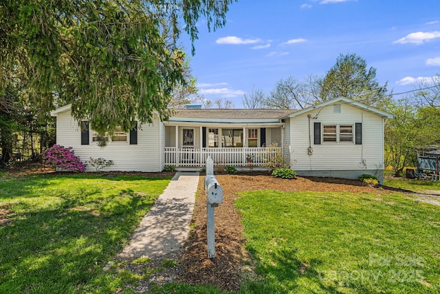 ranch-style home featuring a front yard and covered porch