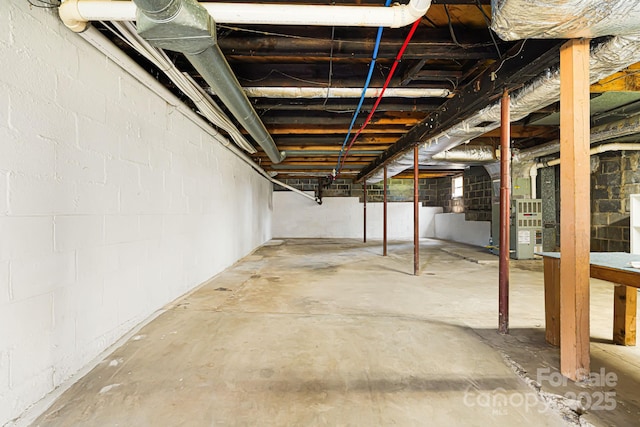 unfinished basement featuring heating unit