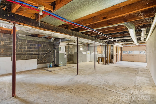 basement with heating unit and independent washer and dryer