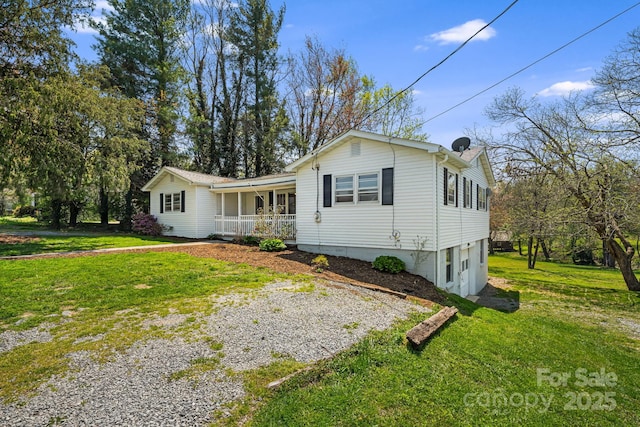 single story home featuring a front lawn, driveway, and covered porch