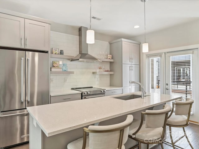520 Sedgefield Park Dr, Charlotte, NC 28203 - kitchen featuring wall chimney range hood, open shelves, a sink, decorative backsplash, and appliances with stainless steel finishes