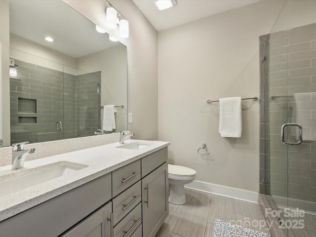 520 Sedgefield Park Dr, Charlotte, NC 28203 - bathroom featuring double vanity, a shower stall, baseboards, and a sink