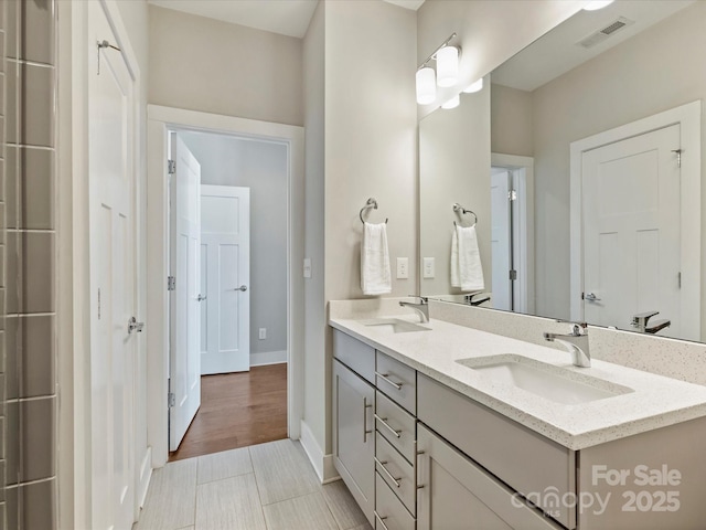 520 Sedgefield Park Dr, Charlotte, NC 28203 - full bath featuring baseboards, visible vents, a sink, and double vanity