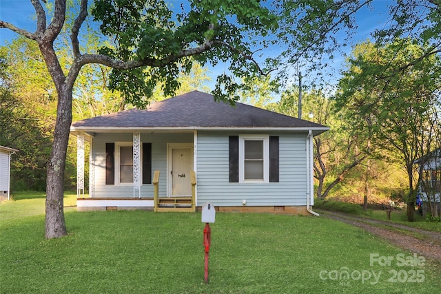 bungalow-style home featuring crawl space, covered porch, a front yard, and roof with shingles