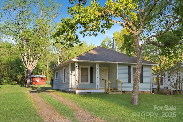 bungalow featuring a storage shed, crawl space, a front yard, and covered porch