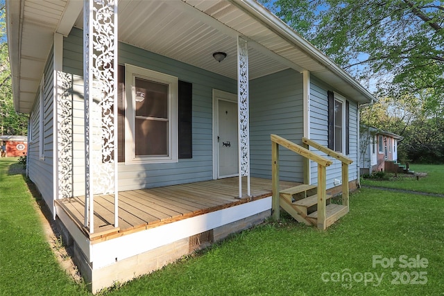 doorway to property with covered porch and a yard