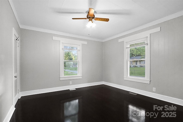 unfurnished room with a ceiling fan, crown molding, and plenty of natural light