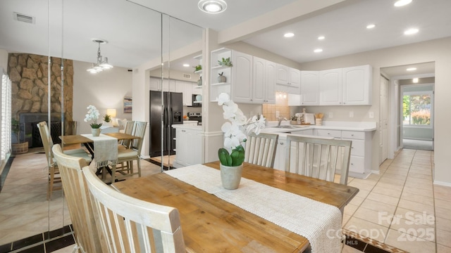 dining area with light tile patterned flooring, visible vents, recessed lighting, and baseboards