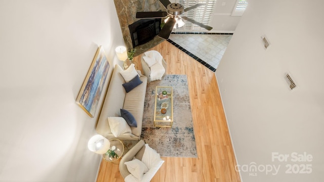 living room with ceiling fan and wood finished floors