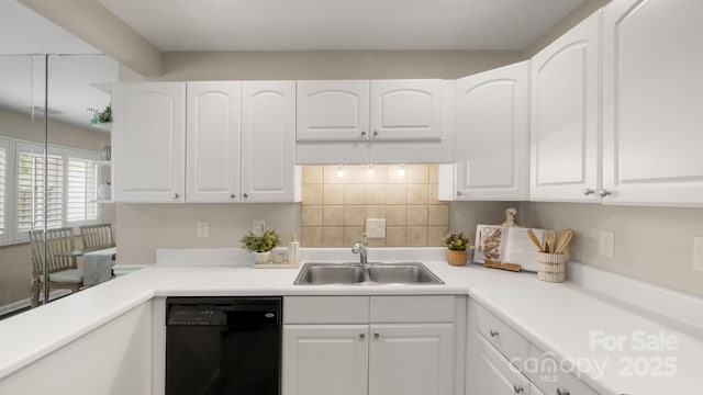 kitchen with black dishwasher, a sink, white cabinetry, and decorative backsplash