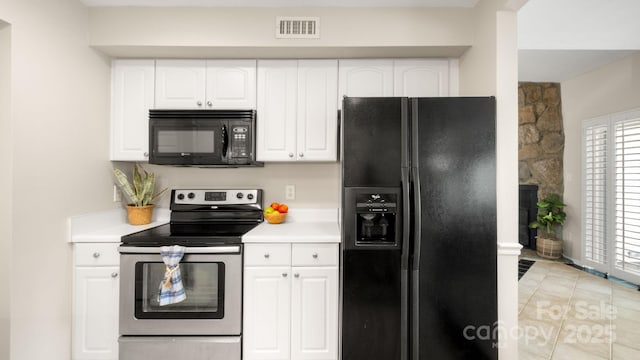 kitchen with visible vents, black appliances, white cabinets, and light countertops