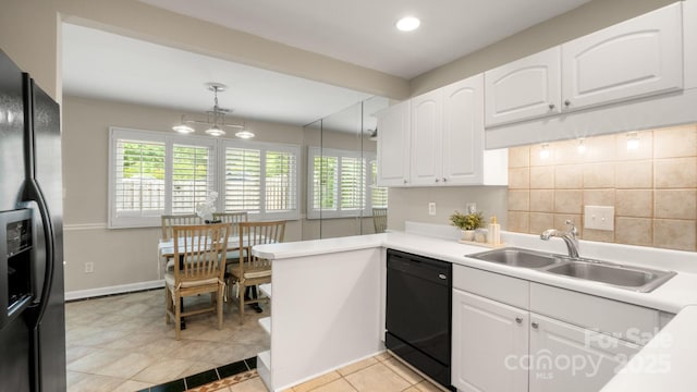 kitchen featuring black appliances, recessed lighting, a sink, and white cabinetry