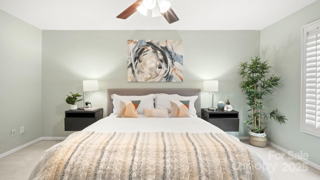 bedroom with ceiling fan, carpet flooring, and baseboards
