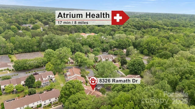 drone / aerial view with a residential view and a forest view