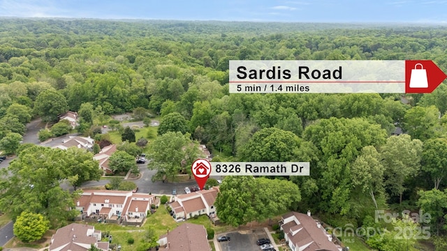 birds eye view of property with a residential view and a view of trees