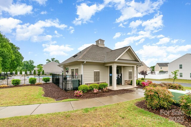 3033 Green Apple Dr, Dallas, NC 28034 - view of front of house with a chimney, fence, a front yard, and roof with shingles