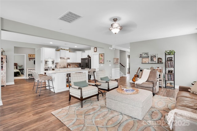 2655 Stonewood Vw, Kannapolis, NC 28081 - living area with wood finished floors, stairs, baseboards, and recessed lighting