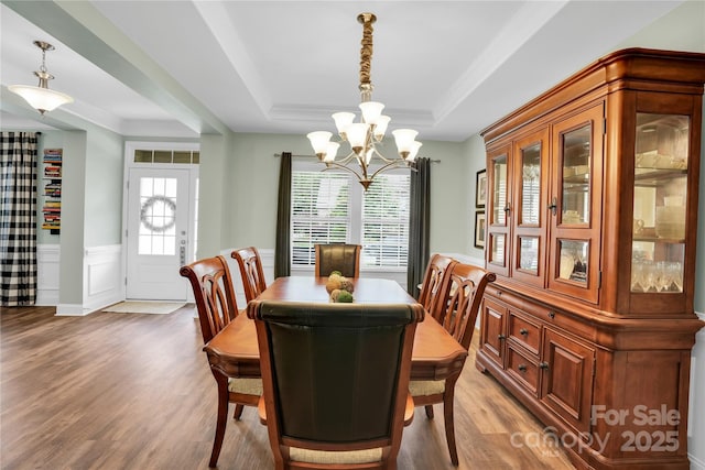 2655 Stonewood Vw, Kannapolis, NC 28081 - dining room featuring a chandelier, a raised ceiling, light wood finished floors, a wainscoted wall, and crown molding