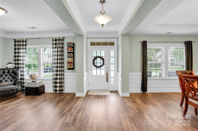 2655 Stonewood Vw, Kannapolis, NC 28081 - entryway featuring wood finished floors, plenty of natural light, wainscoting, crown molding, and a decorative wall