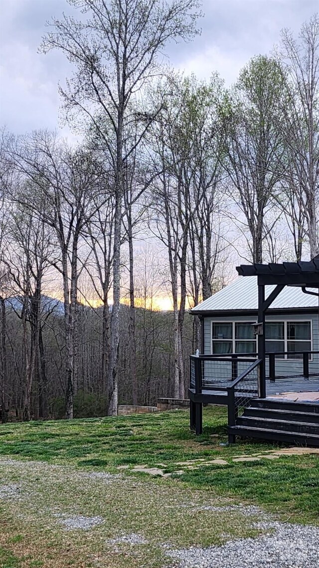 4107 Sandy Plains Rd, Tryon, NC 28782 - yard at dusk featuring a wooden deck and a yard