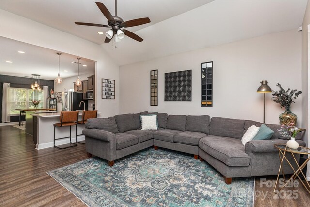 living area featuring dark wood-type flooring, lofted ceiling, ceiling fan, and recessed lighting