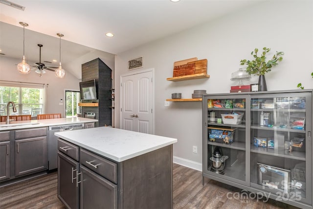 kitchen featuring a center island, a sink, dark wood finished floors, visible vents, and ceiling fan