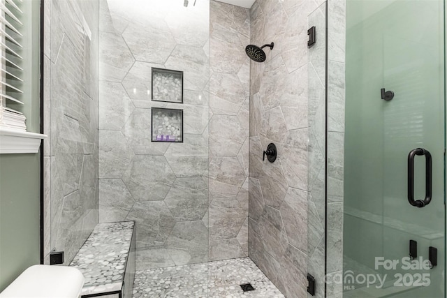 full bathroom with toilet and a stall shower