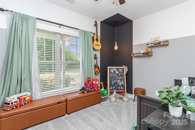 rec room with baseboards, a ceiling fan, and visible vents