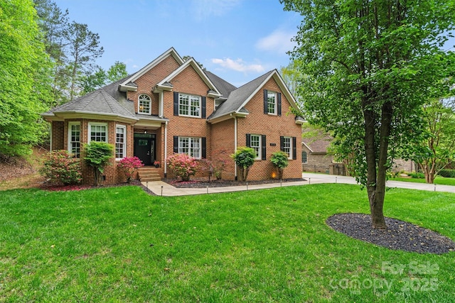 traditional-style home with a front lawn and brick siding
