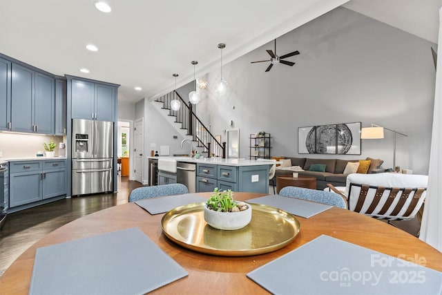 dining space with recessed lighting, lofted ceiling, dark wood-type flooring, stairs, and ceiling fan