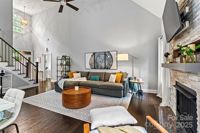 living room featuring wood finished floors, a ceiling fan, and high vaulted ceiling