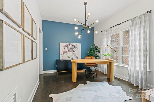 home office featuring wood finished floors, baseboards, and a notable chandelier