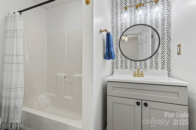 full bathroom featuring vanity and shower / bathtub combination with curtain