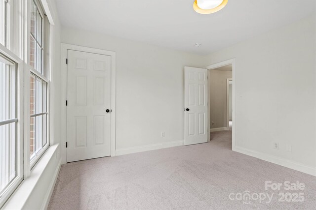 carpeted spare room with baseboards