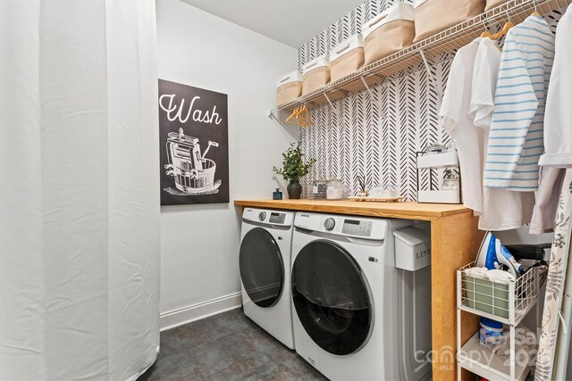 laundry area with baseboards, laundry area, and washer and clothes dryer