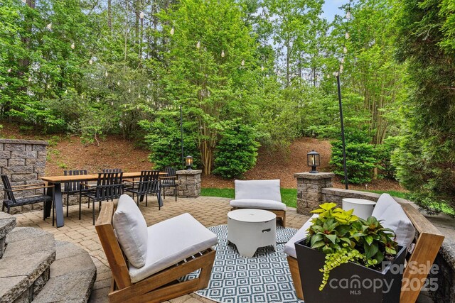 view of patio with outdoor lounge area and outdoor dining area