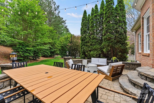 view of patio / terrace featuring outdoor dining space and an outdoor living space