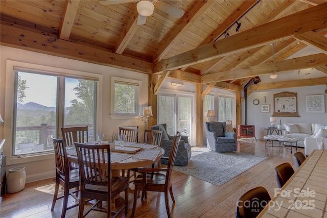 dining space featuring light wood-style floors, plenty of natural light, and wooden ceiling