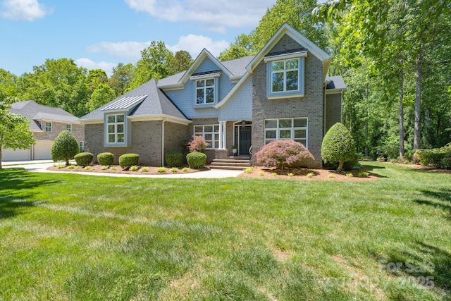 craftsman inspired home featuring brick siding and a front lawn