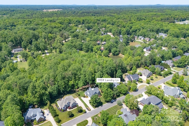 bird's eye view featuring a wooded view
