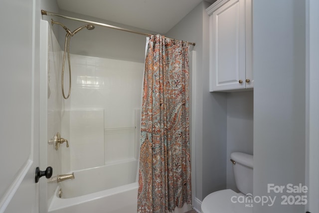 bathroom featuring shower / bathtub combination with curtain and toilet
