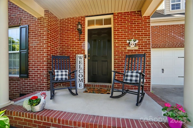 entrance to property featuring brick siding and covered porch