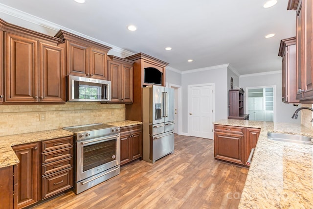 1468 Woodhurst Dr, Rock Hill, SC 29732 - kitchen with appliances with stainless steel finishes, light stone countertops, light wood-style flooring, decorative backsplash, and ornamental molding