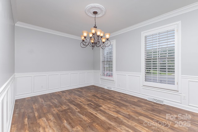 1468 Woodhurst Dr, Rock Hill, SC 29732 - empty room featuring a chandelier, ornamental molding, wainscoting, dark wood-style floors, and a decorative wall