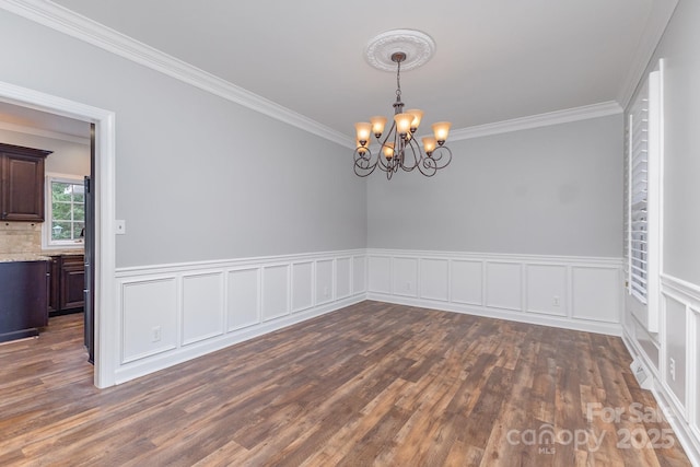 1468 Woodhurst Dr, Rock Hill, SC 29732 - spare room featuring crown molding, a chandelier, dark wood-style flooring, and wainscoting